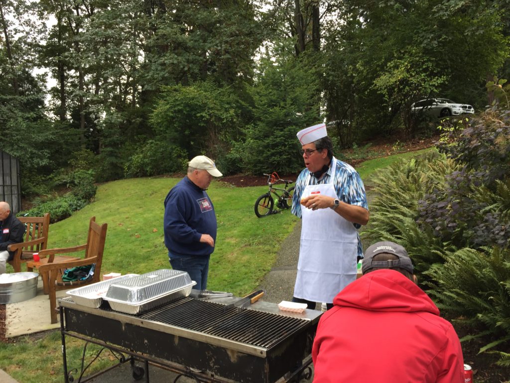 Outdoor barbecue with chef and guests
