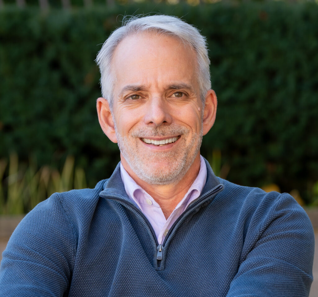 Smiling middle-aged man portrait in garden